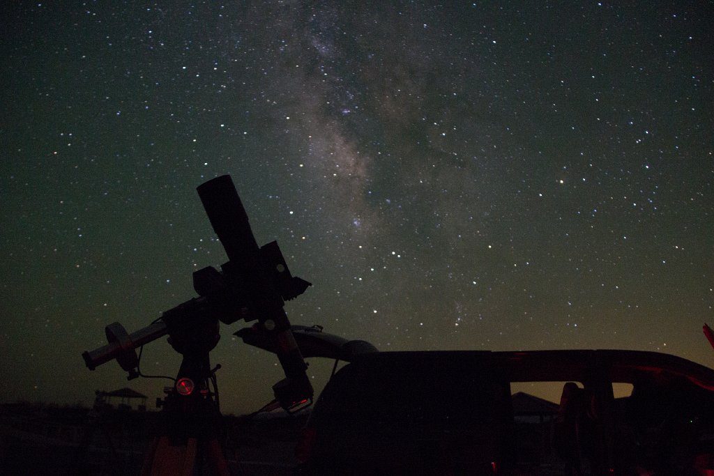 IMG_2792.jpg - Silhouette of my 4-inch refractor, taking an astrophoto. Van behind with the tailgate open, and the Milky Way.